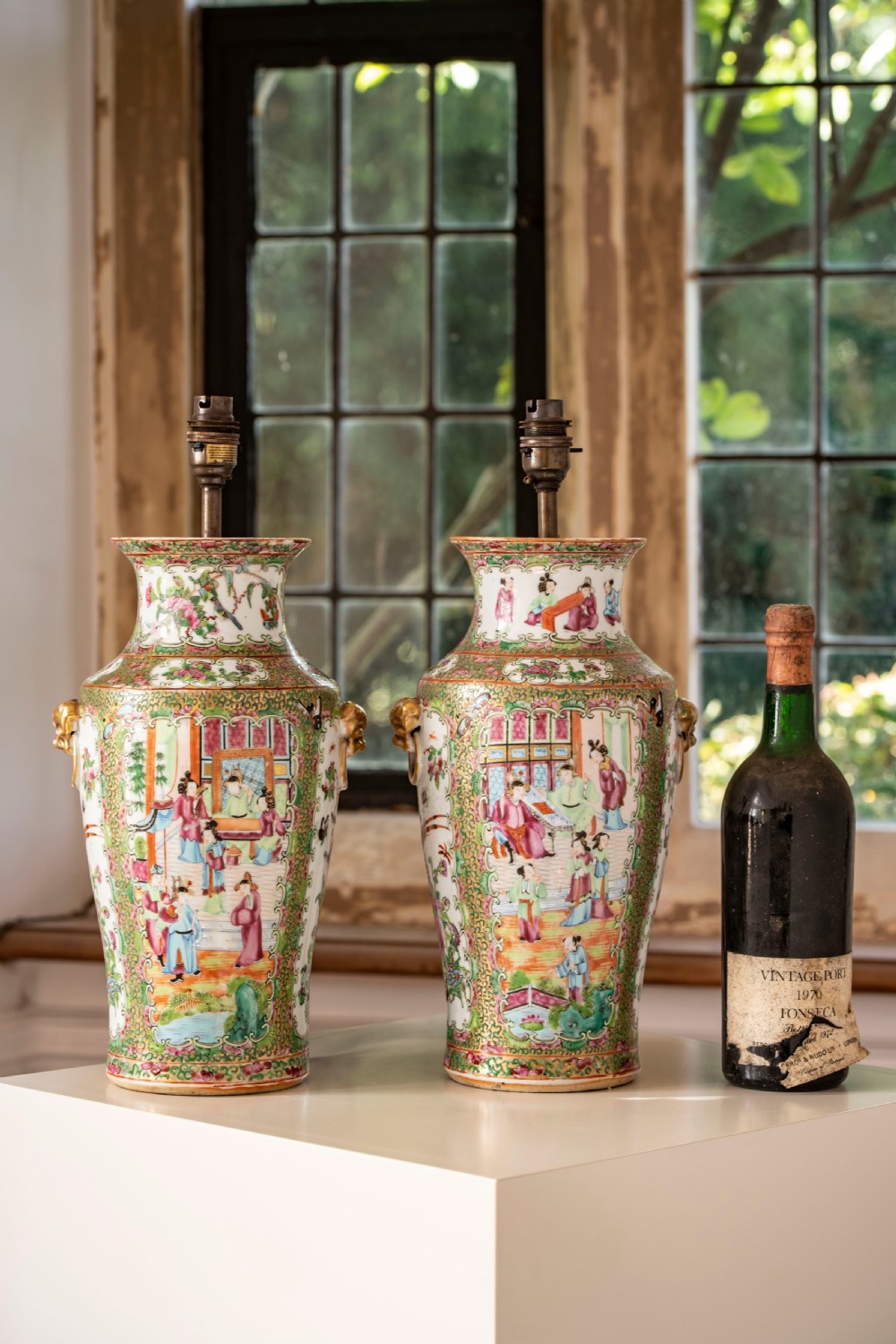A pair of large Chinese Canton porcelain vase lamps with hand-painted polychrome figural panels, floral borders, and brass light fittings. View III