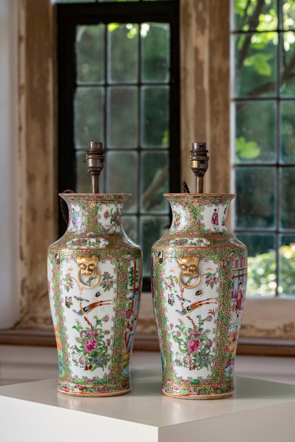 A pair of large Chinese Canton porcelain vase lamps with hand-painted polychrome figural panels, floral borders, and brass light fittings. View VII