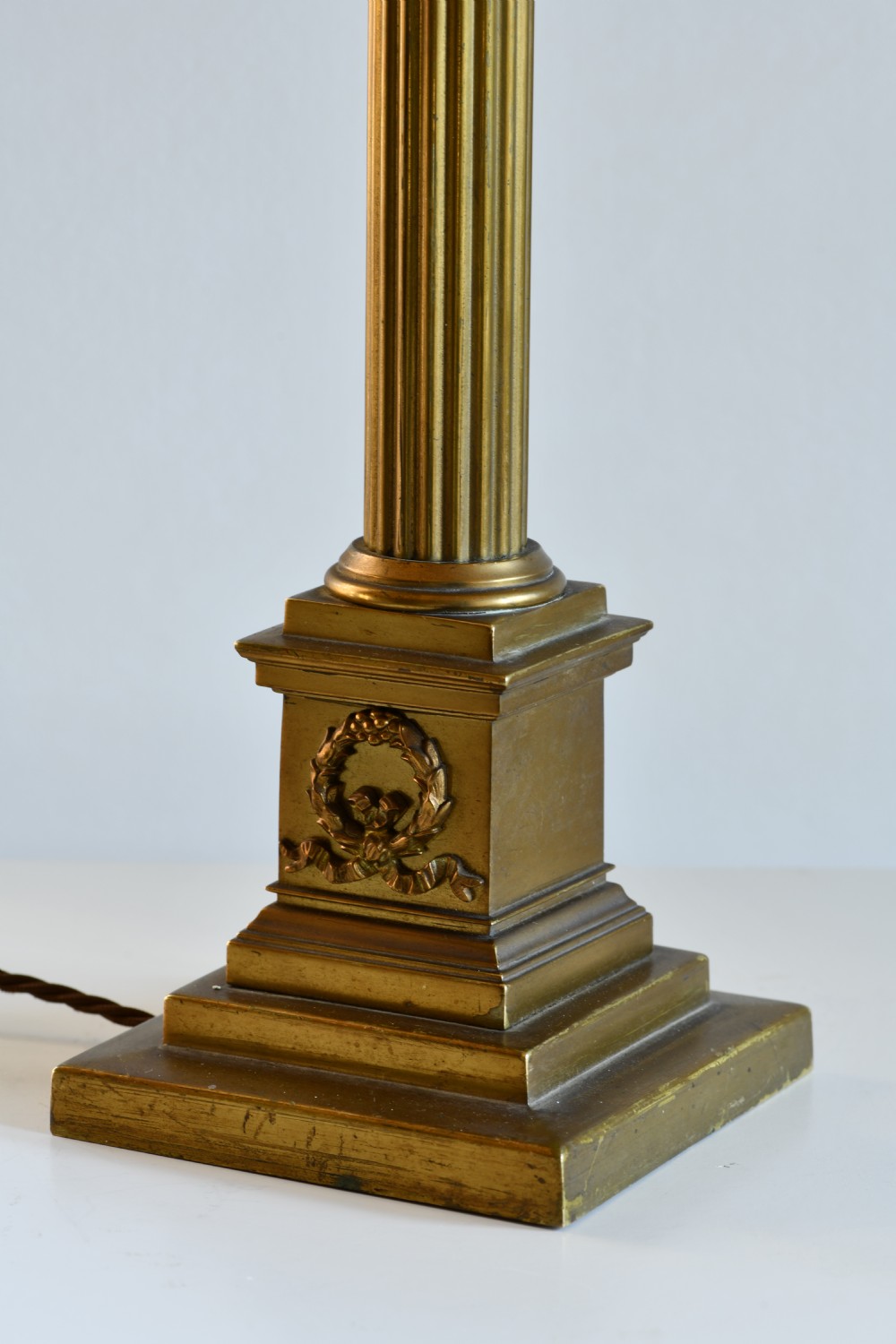 A late nineteenth-century brass table lamp featuring a fluted Corinthian column on a square stepped pedestal base. View IV