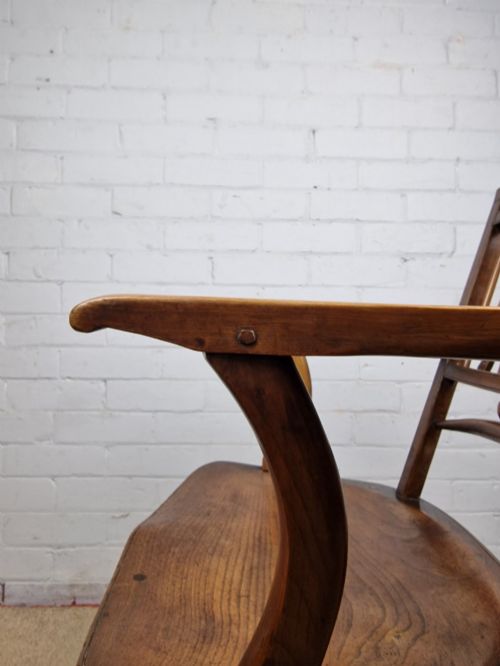 fig 1. A mid-19th-century wooden Mendlesham armchair featuring a squared backrest with turned wooden spheres, pierced splats, curved arms, and a shaped seat on turned legs.