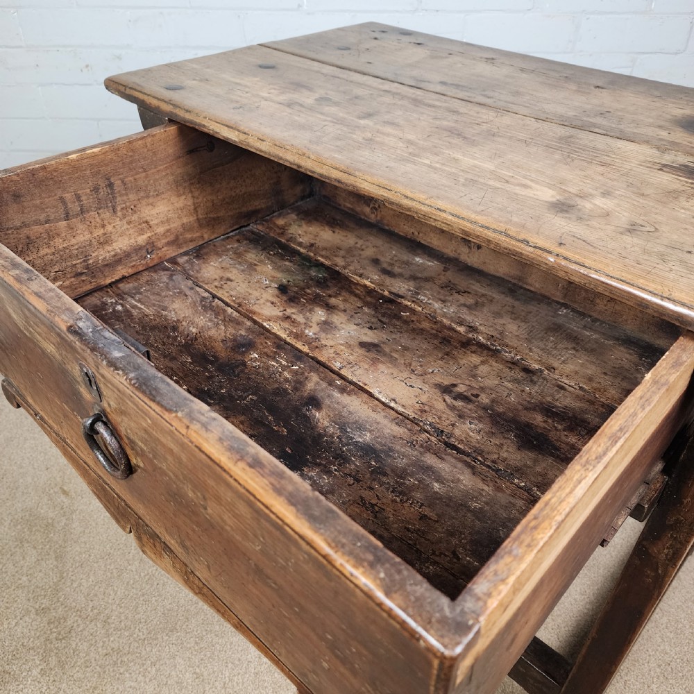 A 17th-century Spanish chestnut side table with a single drawer featuring a central wrought iron ring pull and a box stretcher base. View VI