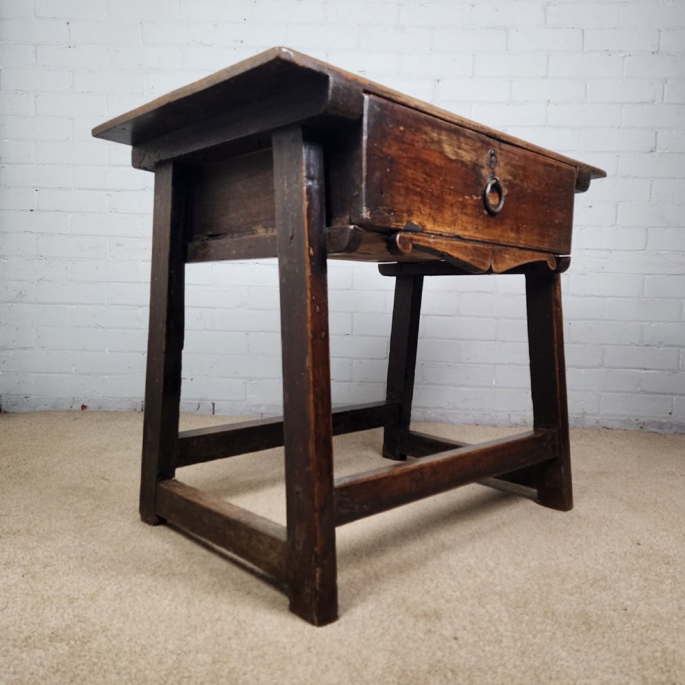 A 17th-century Spanish chestnut side table with a single drawer featuring a central wrought iron ring pull and a box stretcher base. View VII