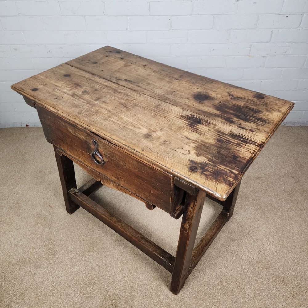 A 17th-century Spanish chestnut side table with a single drawer featuring a central wrought iron ring pull and a box stretcher base. View XI