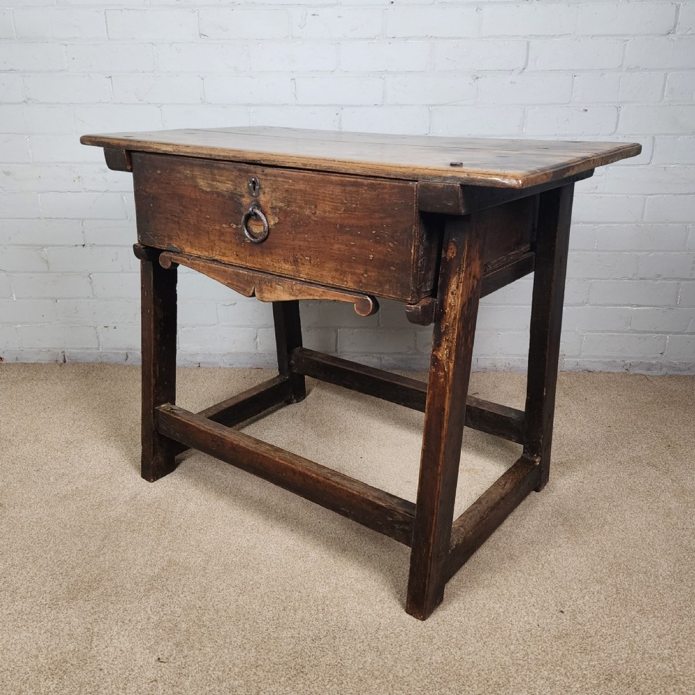 A 17th-century Spanish chestnut side table with a single drawer featuring a central wrought iron ring pull and a box stretcher base. View XII