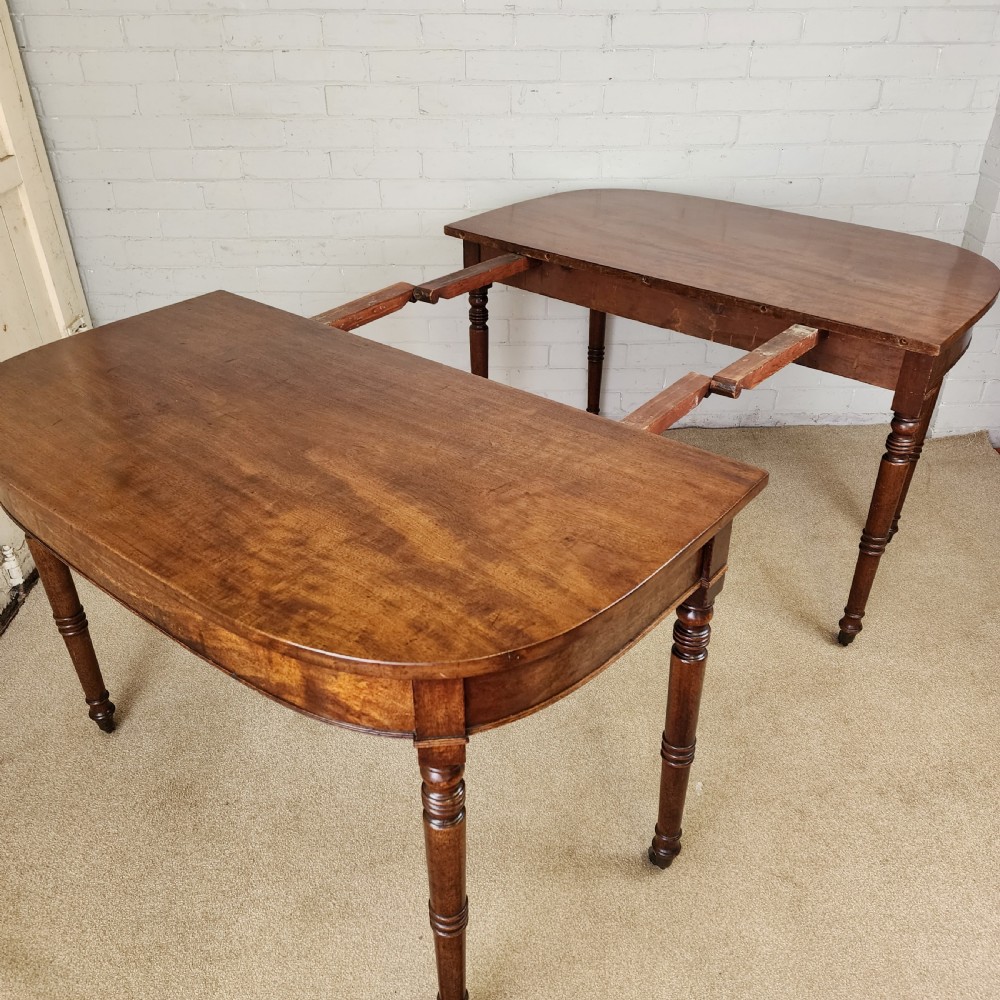 A George IV mahogany extending dining table featuring rounded D-ends, a polished timber surface, and turned legs. View VII
