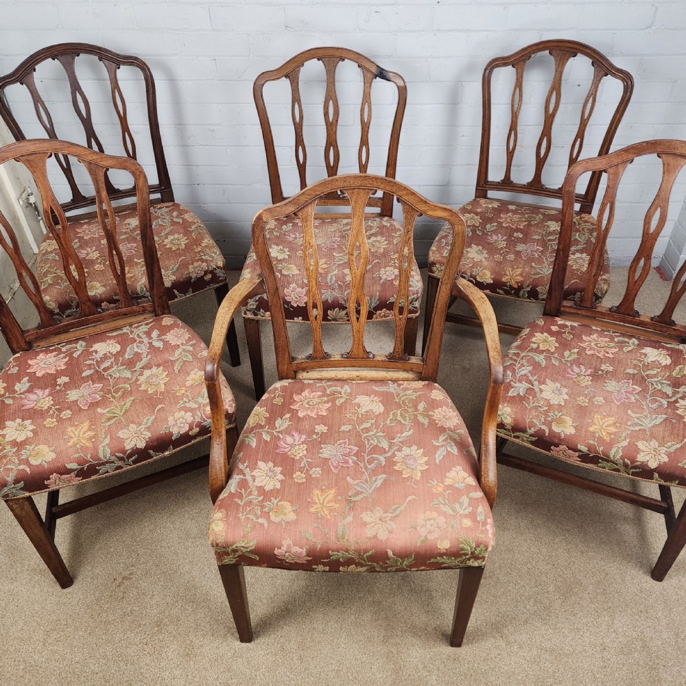 A set of six early 19th-century Georgian mahogany dining chairs with carved pierced splats and floral upholstered seats, including two carver armchairs.