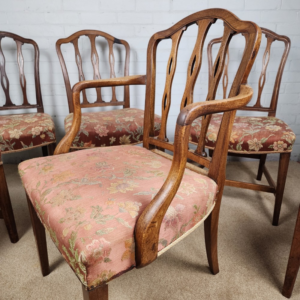 A set of six early 19th-century Georgian mahogany dining chairs with carved pierced splats and floral upholstered seats, including two carver armchairs. View V