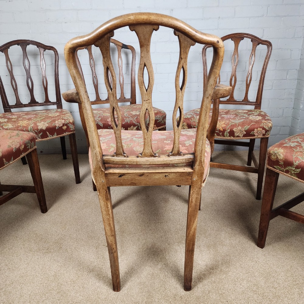 A set of six early 19th-century Georgian mahogany dining chairs with carved pierced splats and floral upholstered seats, including two carver armchairs. View VI