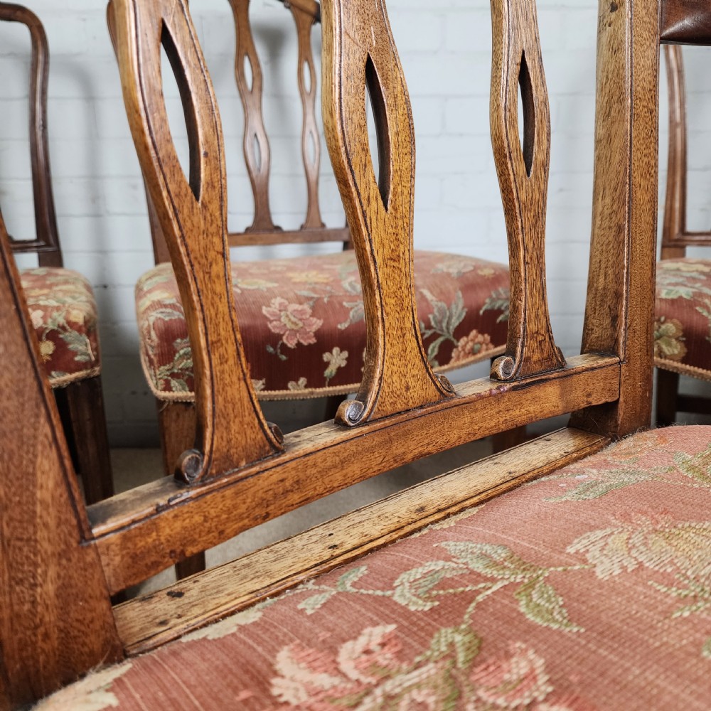 A set of six early 19th-century Georgian mahogany dining chairs with carved pierced splats and floral upholstered seats, including two carver armchairs. View VII