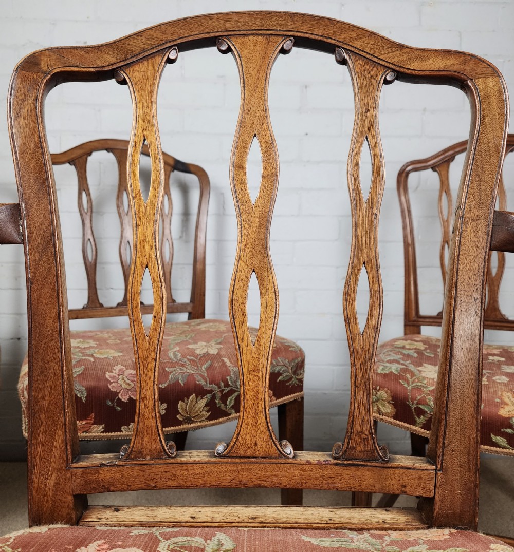 A set of six early 19th-century Georgian mahogany dining chairs with carved pierced splats and floral upholstered seats, including two carver armchairs. View VIII
