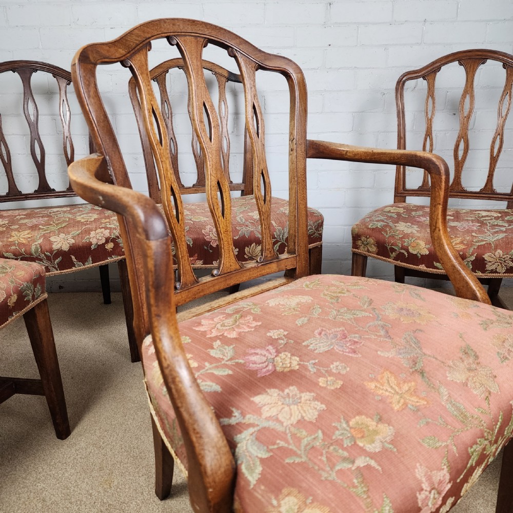 A set of six early 19th-century Georgian mahogany dining chairs with carved pierced splats and floral upholstered seats, including two carver armchairs. View IX
