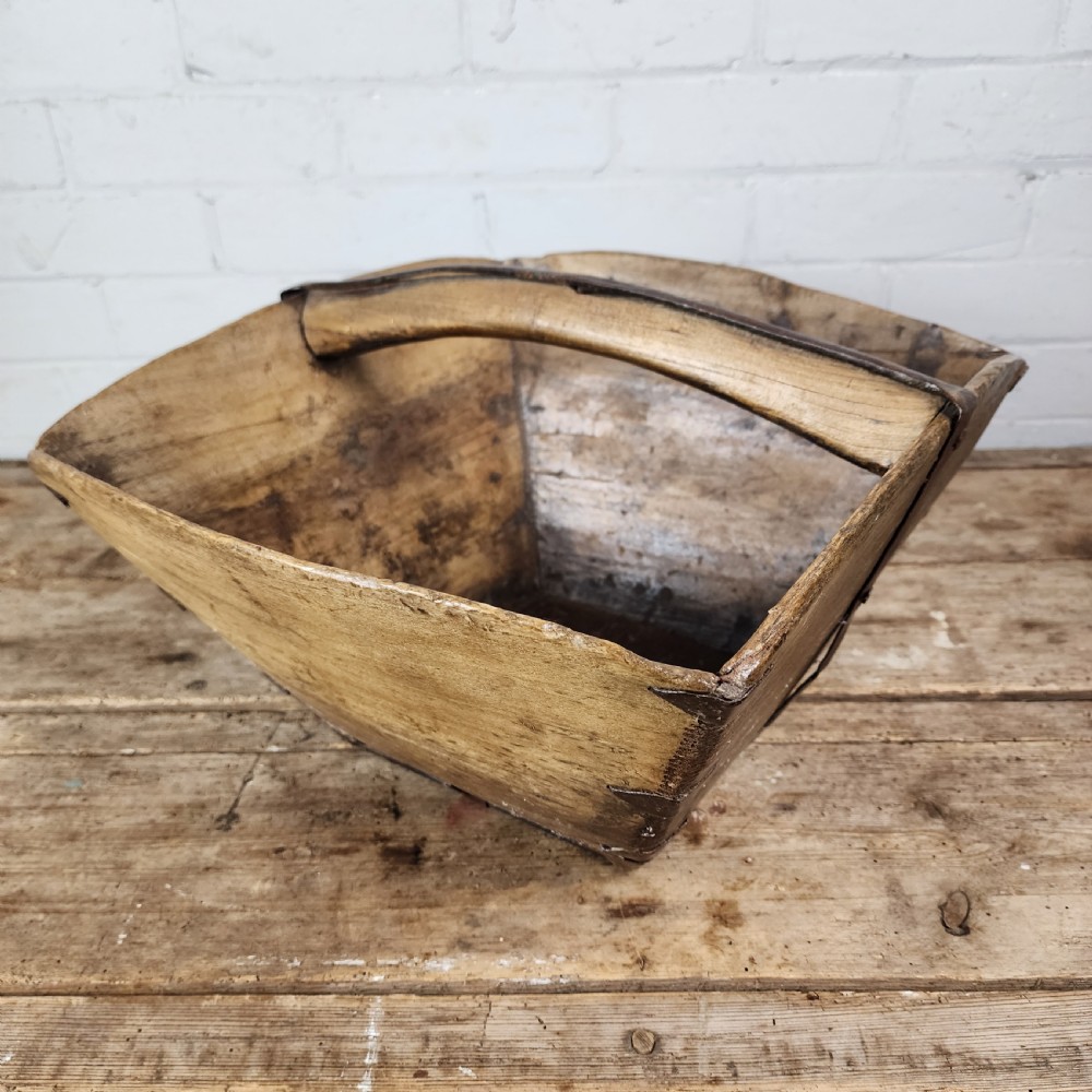 A nineteenth-century wooden garden trug featuring iron rim strapping, metal corner reinforcements, and a carved central carrying handle. View IV