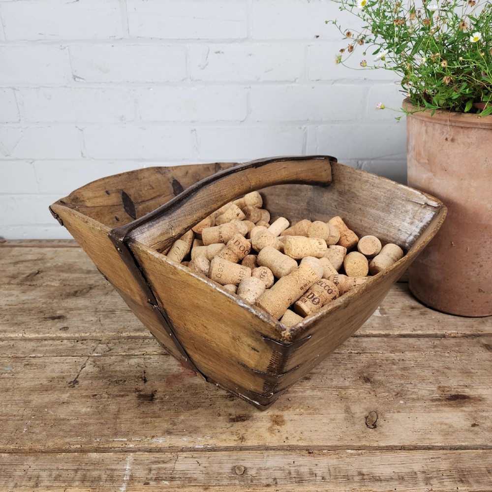 A nineteenth-century wooden garden trug featuring iron rim strapping, metal corner reinforcements, and a carved central carrying handle. View VII