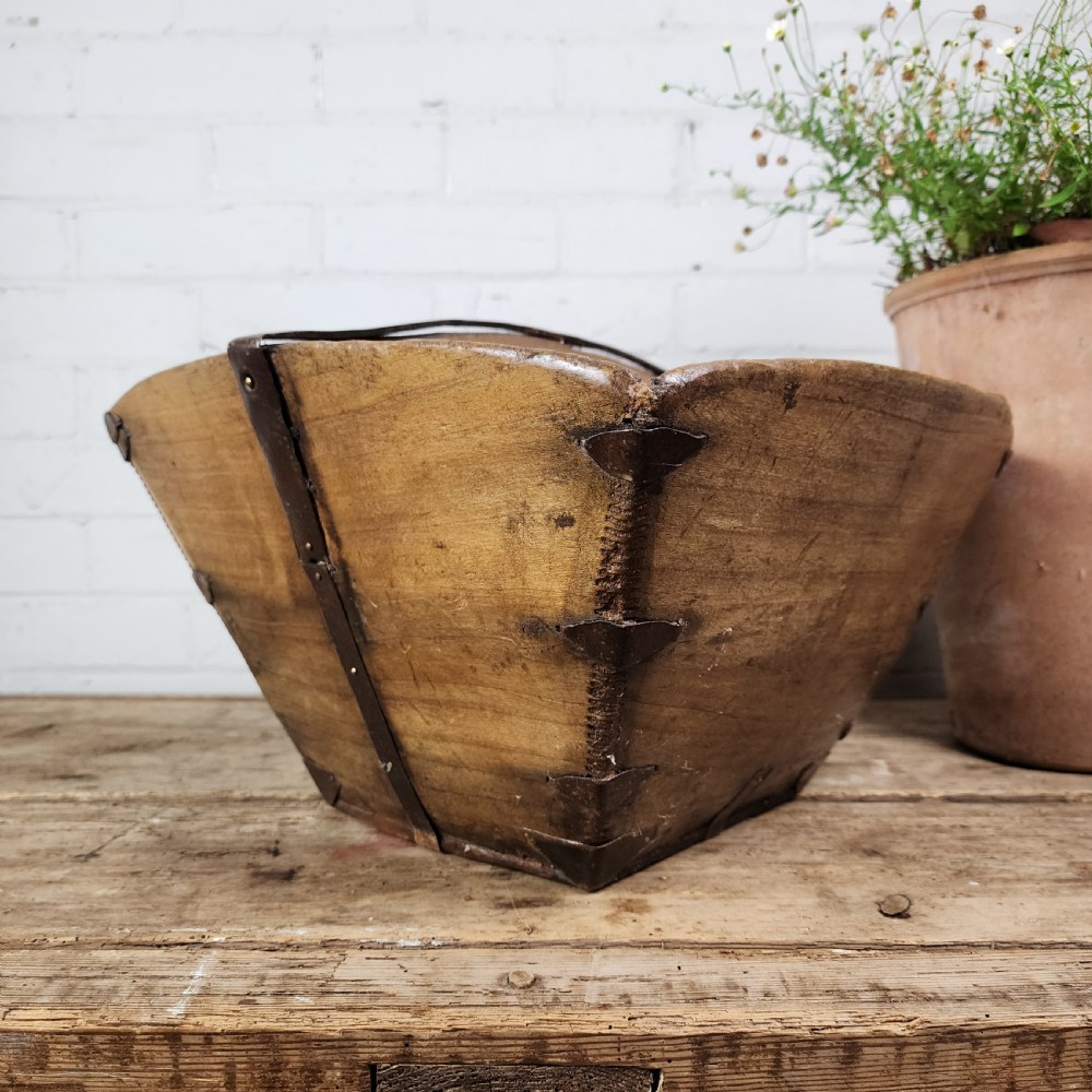 A nineteenth-century wooden garden trug featuring iron rim strapping, metal corner reinforcements, and a carved central carrying handle. View VIII