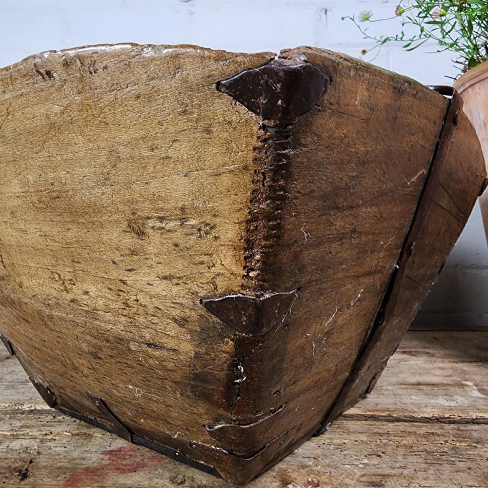 A nineteenth-century wooden garden trug featuring iron rim strapping, metal corner reinforcements, and a carved central carrying handle. View IX