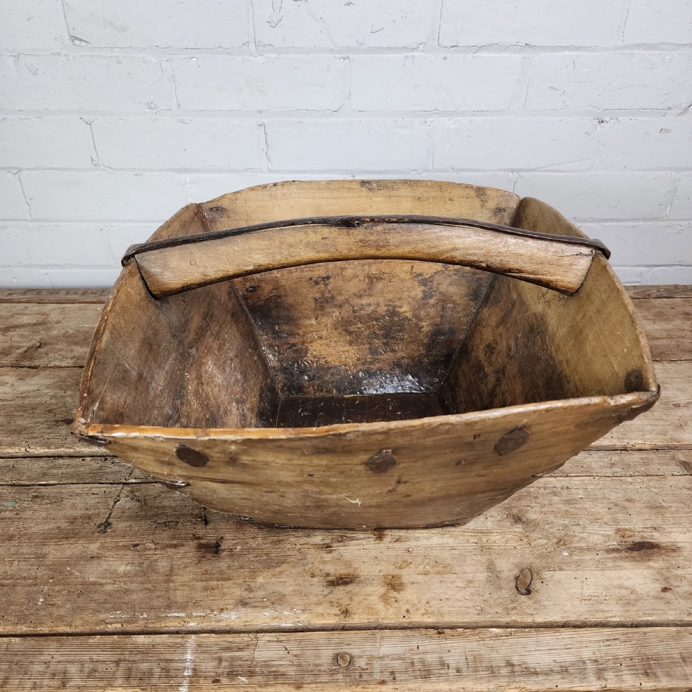 A nineteenth-century wooden garden trug featuring iron rim strapping, metal corner reinforcements, and a carved central carrying handle. View XI