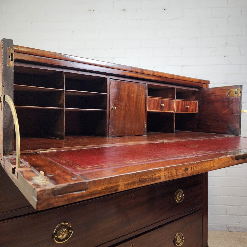 A Georgian mahogany secretaire chest of drawers featuring an open drop-front top section with small fitted drawers and pigeonholes above three lower drawers. View II
