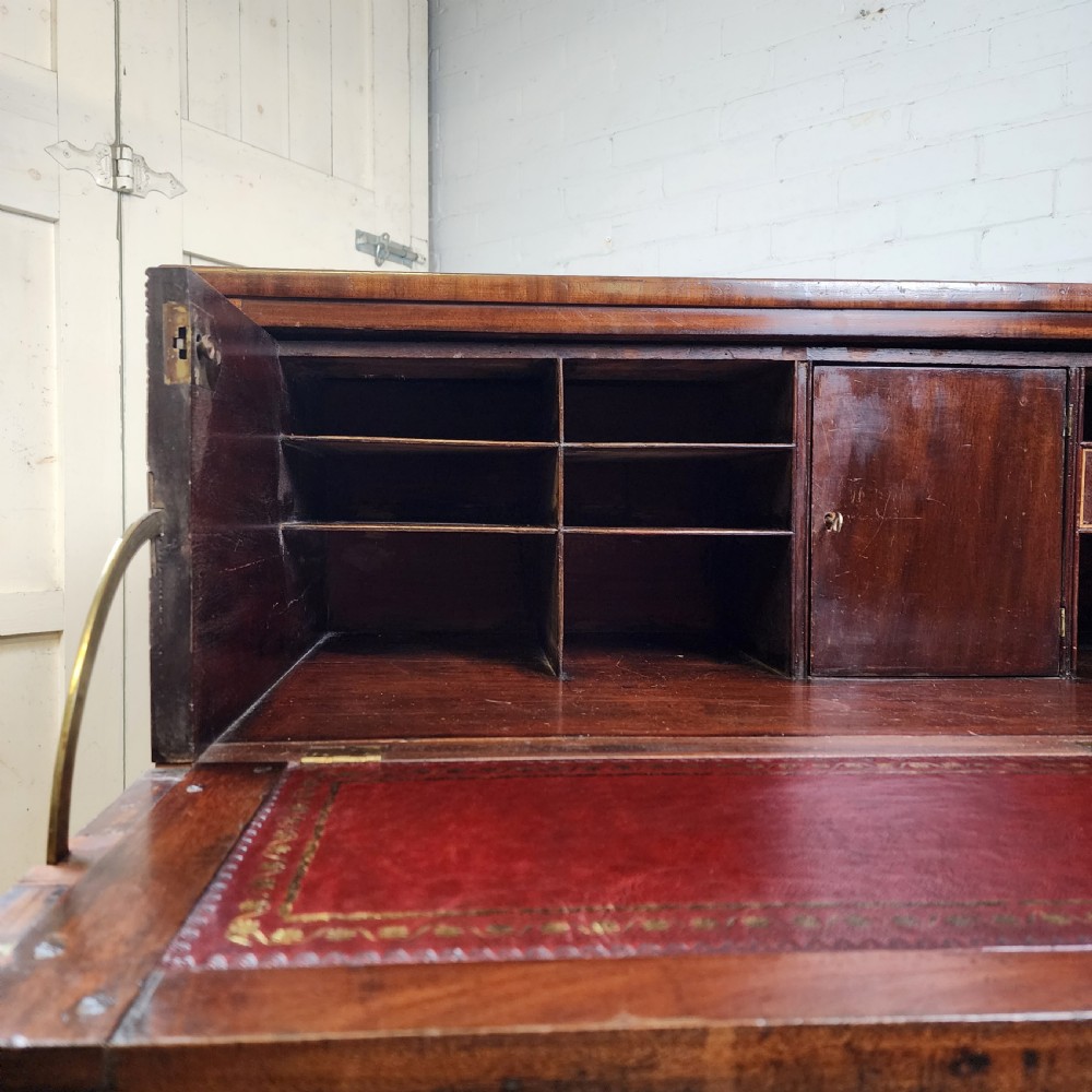 A Georgian mahogany secretaire chest of drawers featuring an open drop-front top section with small fitted drawers and pigeonholes above three lower drawers. View III