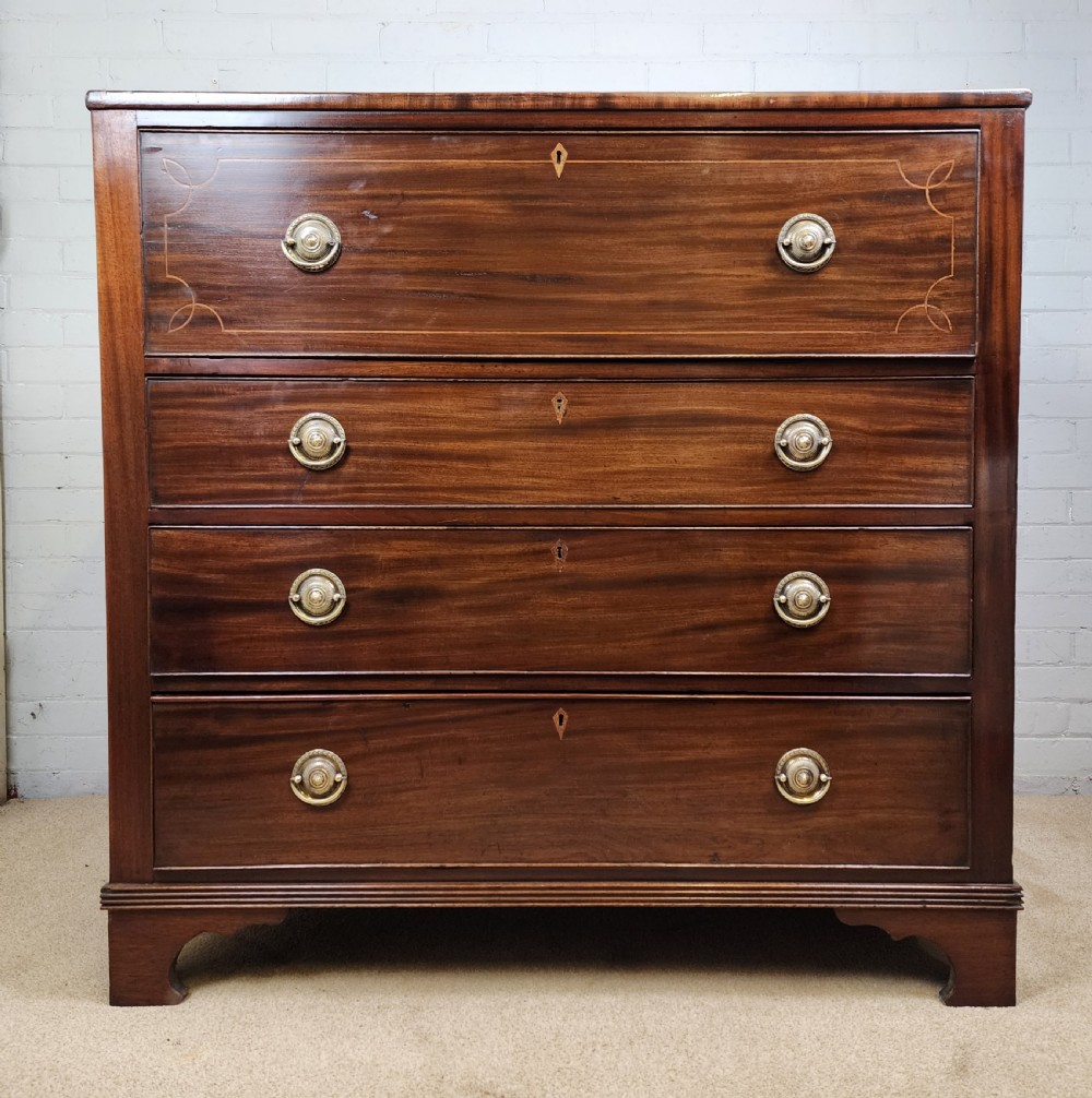 A Georgian mahogany secretaire chest of drawers featuring an open drop-front top section with small fitted drawers and pigeonholes above three lower drawers. View VII