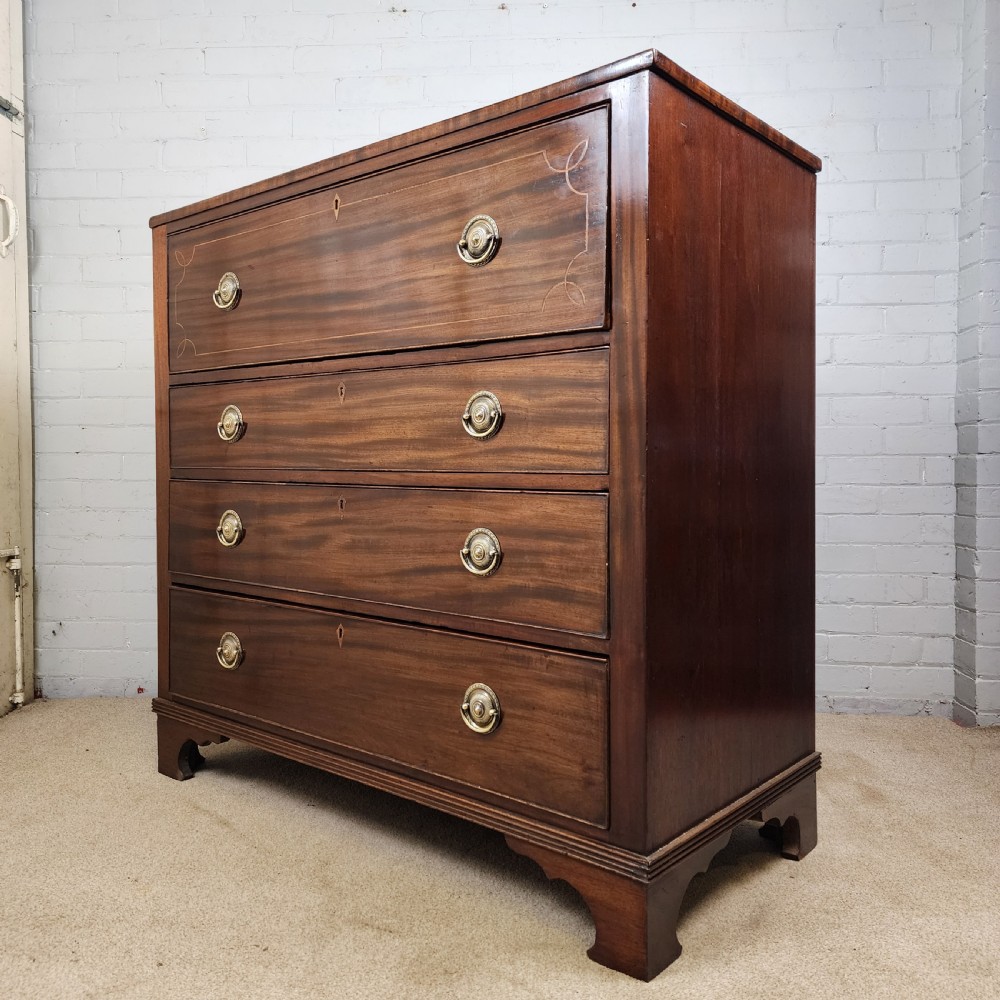 A Georgian mahogany secretaire chest of drawers featuring an open drop-front top section with small fitted drawers and pigeonholes above three lower drawers. View IX