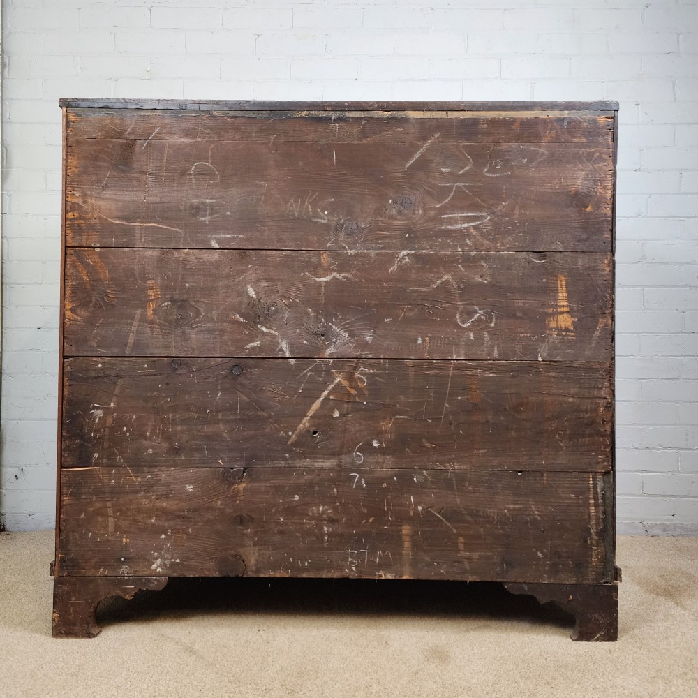 A Georgian mahogany secretaire chest of drawers featuring an open drop-front top section with small fitted drawers and pigeonholes above three lower drawers. View XI