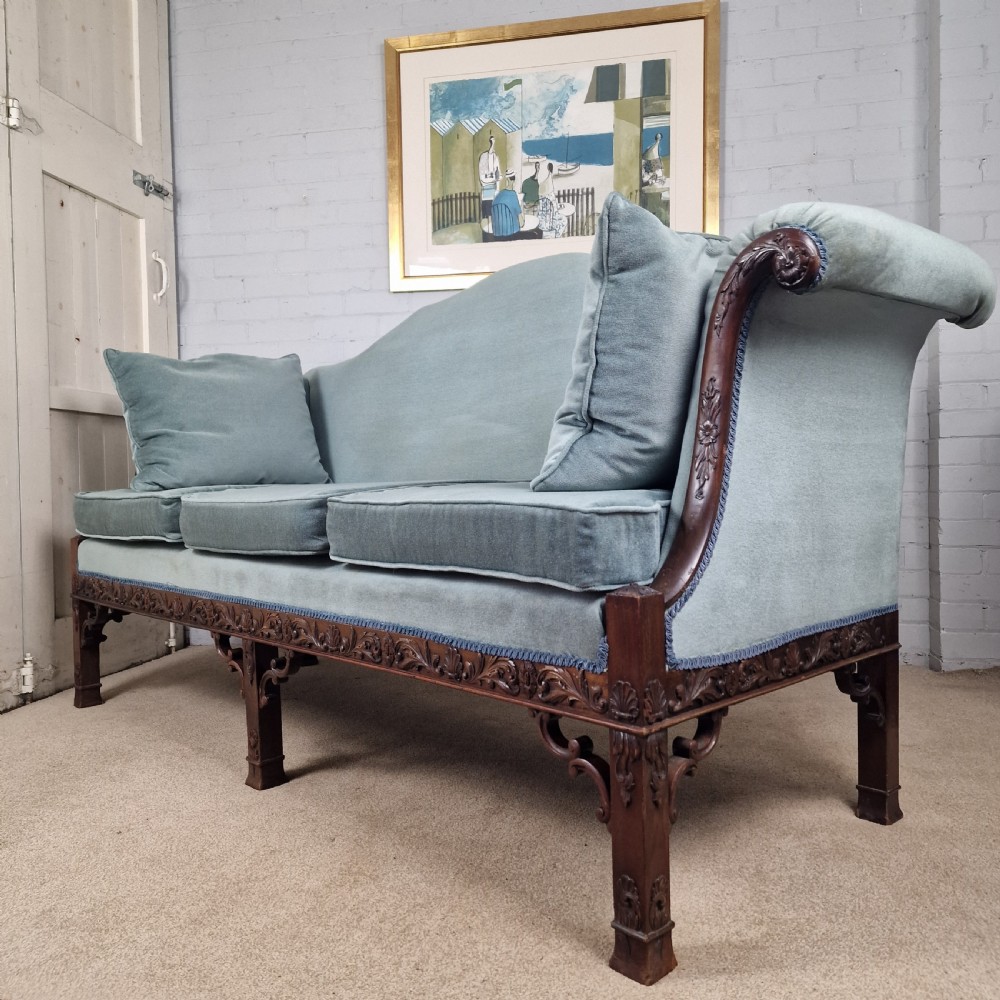 An early twentieth-century Chinese Chippendale style camelback sofa upholstered in light blue velvet with a hand-carved mahogany frame and fretwork legs. View II