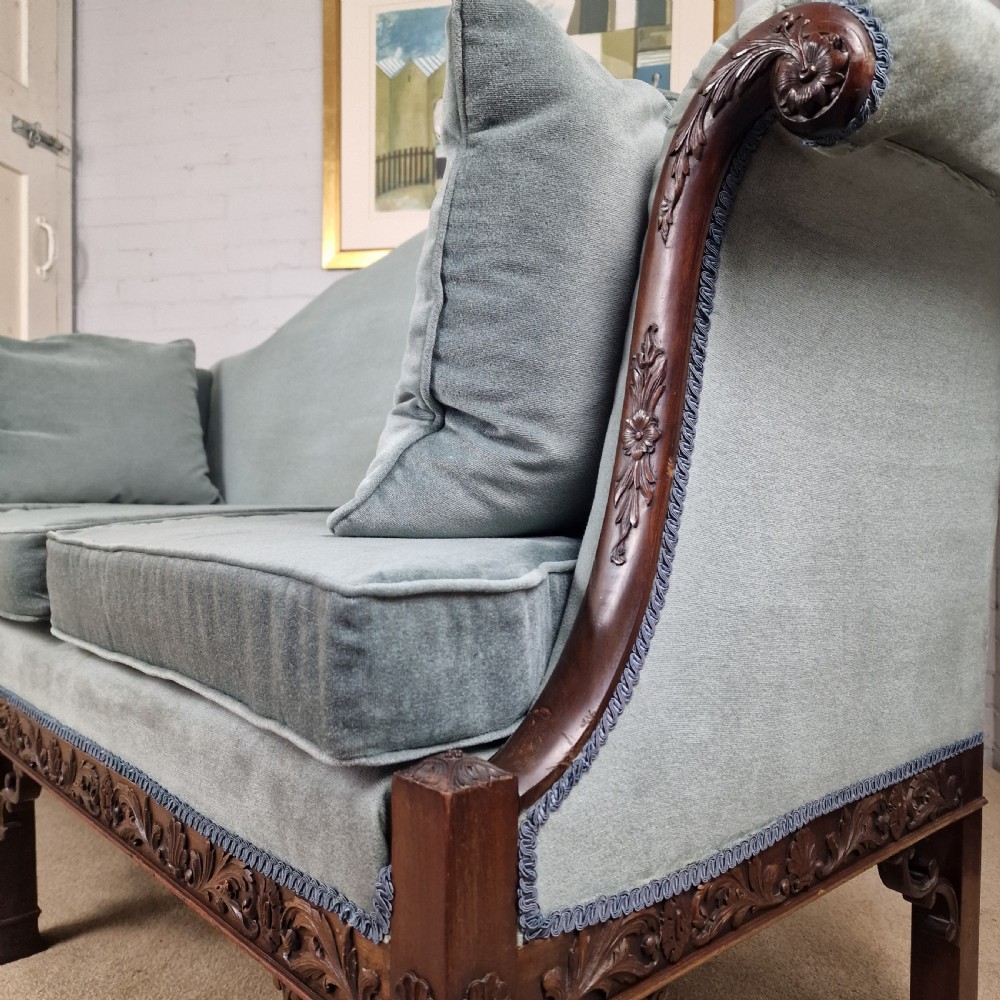 An early twentieth-century Chinese Chippendale style camelback sofa upholstered in light blue velvet with a hand-carved mahogany frame and fretwork legs. View III