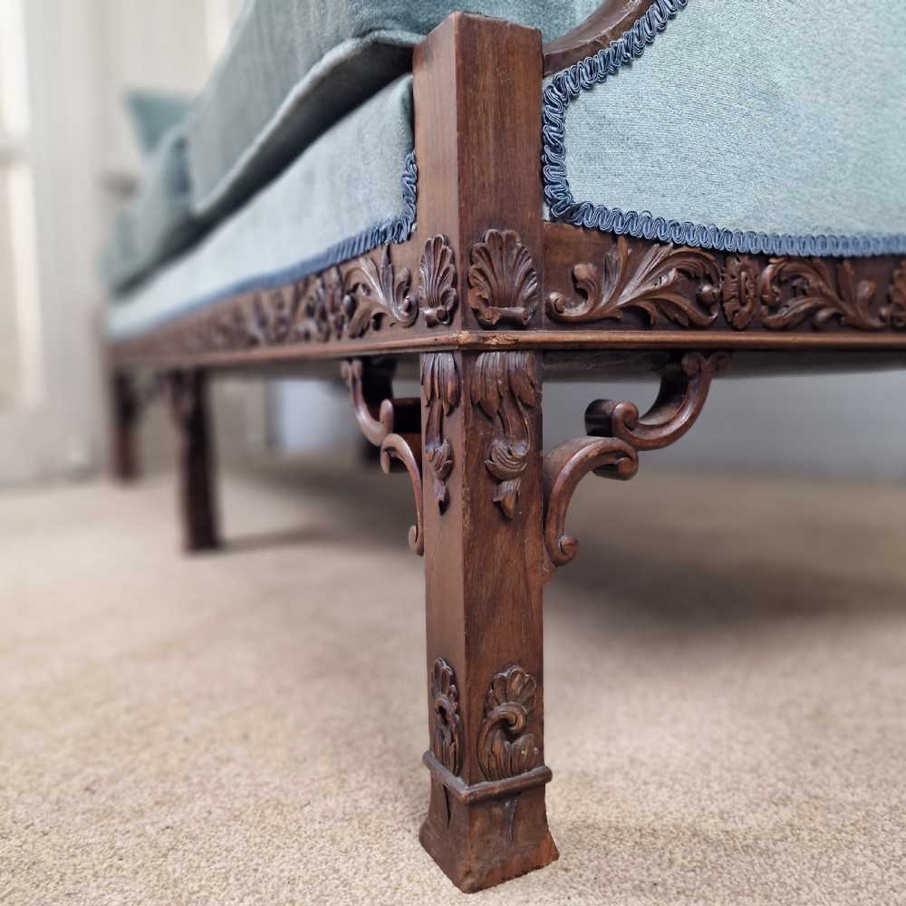 An early twentieth-century Chinese Chippendale style camelback sofa upholstered in light blue velvet with a hand-carved mahogany frame and fretwork legs. View V