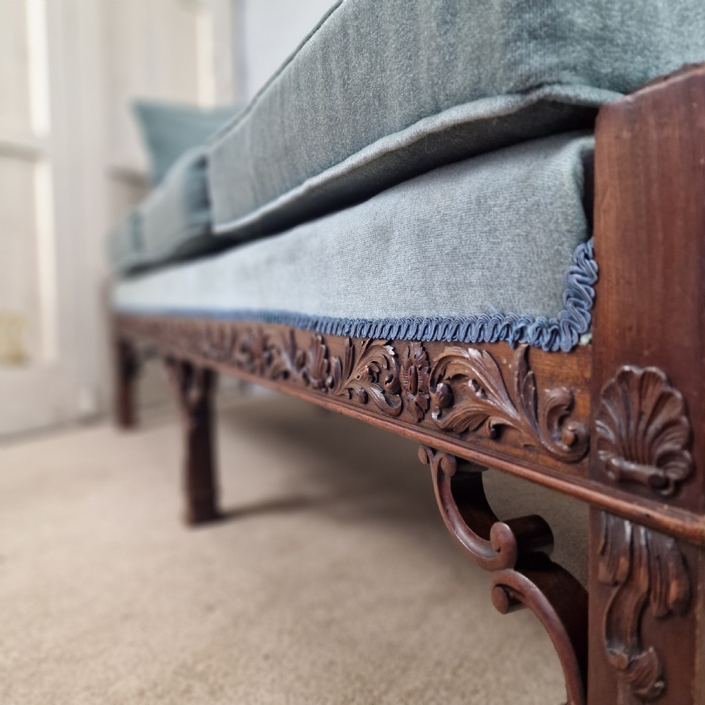 An early twentieth-century Chinese Chippendale style camelback sofa upholstered in light blue velvet with a hand-carved mahogany frame and fretwork legs. View VI