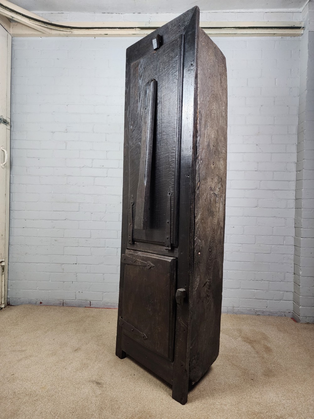 A tall dark oak metamorphic cupboard featuring open shelving, a lower cabinet, and an extended hinged table leaf supported by a angled leg. View VI