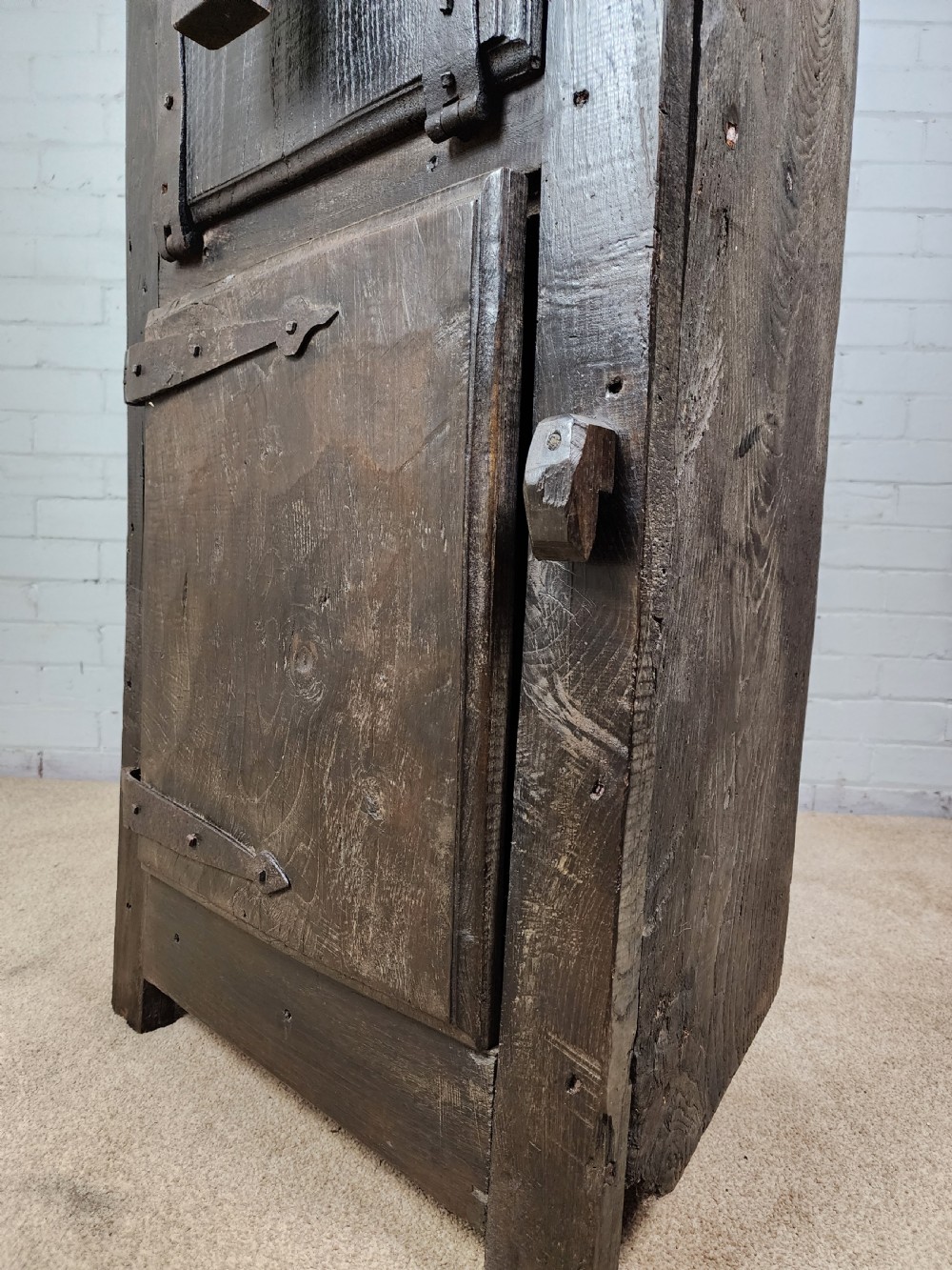A tall dark oak metamorphic cupboard featuring open shelving, a lower cabinet, and an extended hinged table leaf supported by a angled leg. View VIII