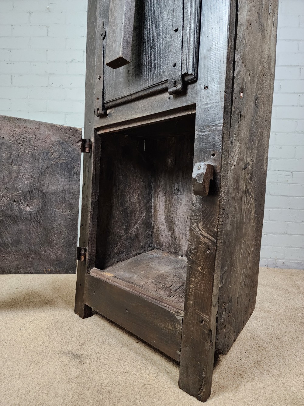 A tall dark oak metamorphic cupboard featuring open shelving, a lower cabinet, and an extended hinged table leaf supported by a angled leg. View IX