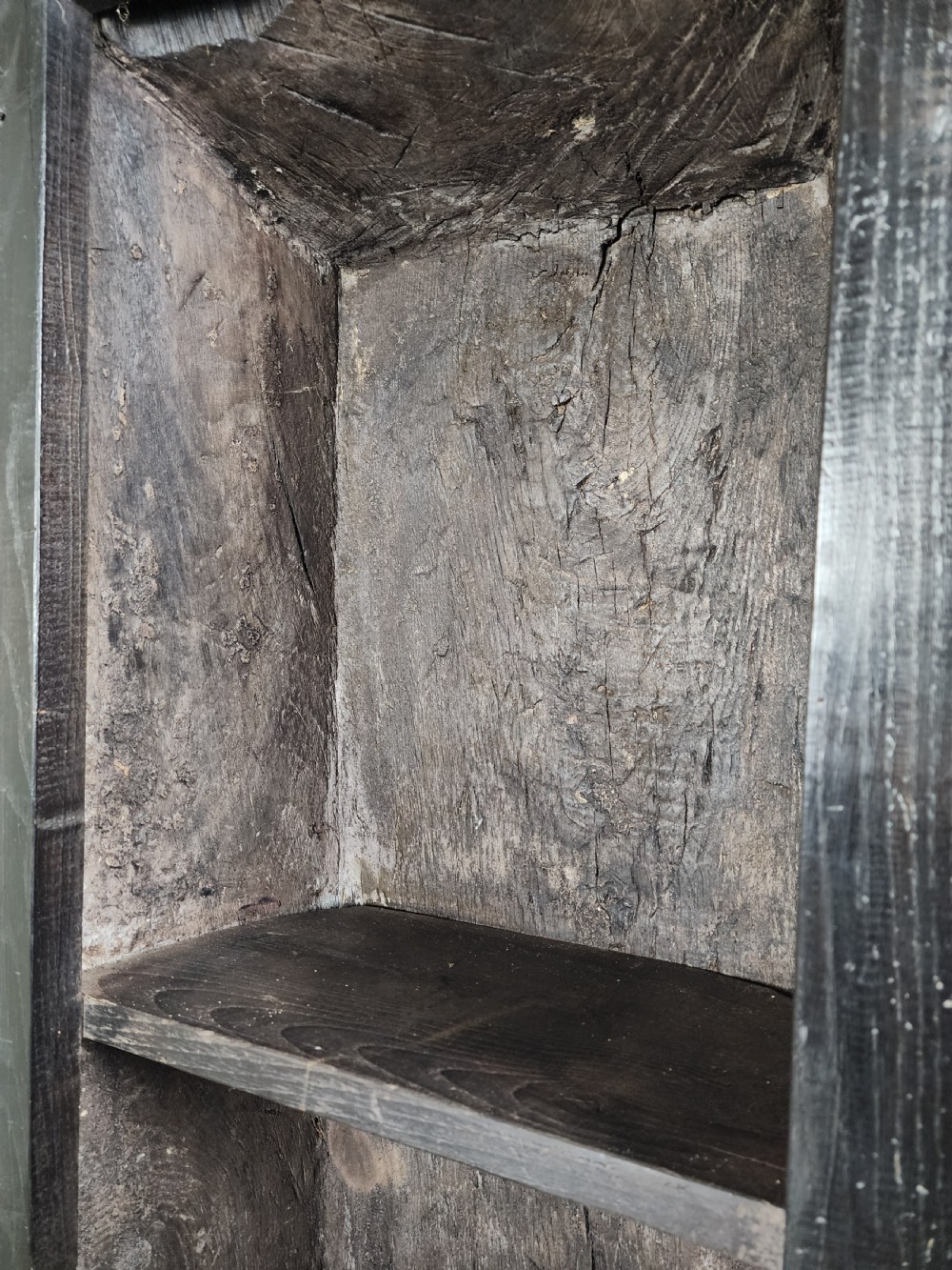 A tall dark oak metamorphic cupboard featuring open shelving, a lower cabinet, and an extended hinged table leaf supported by a angled leg. View XII