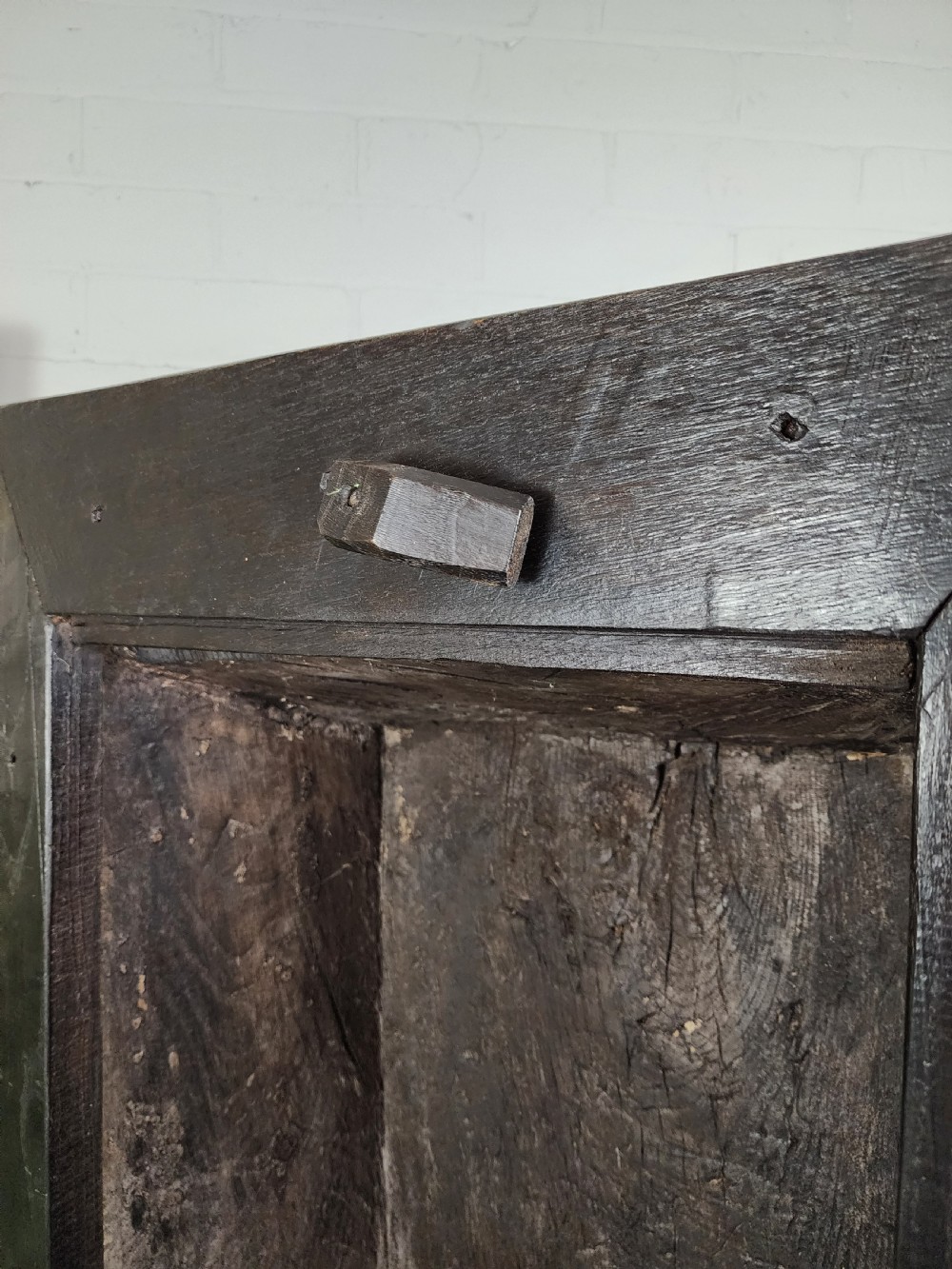 A tall dark oak metamorphic cupboard featuring open shelving, a lower cabinet, and an extended hinged table leaf supported by a angled leg. View XIV