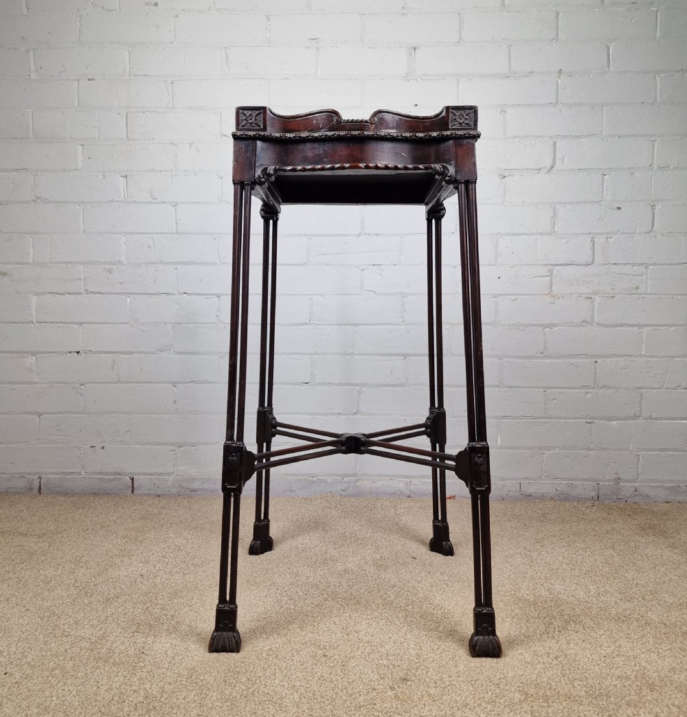 A tall, slender late 18th-century Chinese Chippendale style dark mahogany kettle stand featuring a carved gallery top, clustered column legs, and an X-frame stretcher. View II