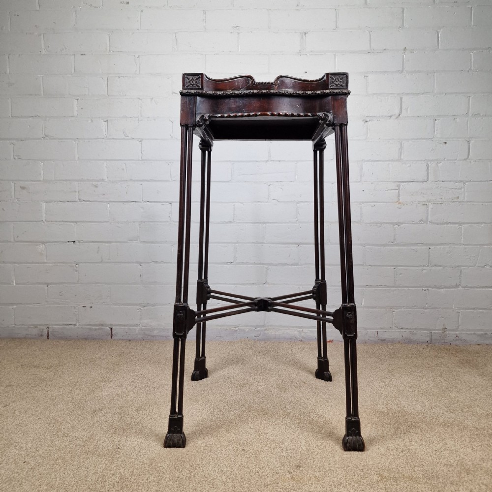 A tall, slender late 18th-century Chinese Chippendale style dark mahogany kettle stand featuring a carved gallery top, clustered column legs, and an X-frame stretcher.