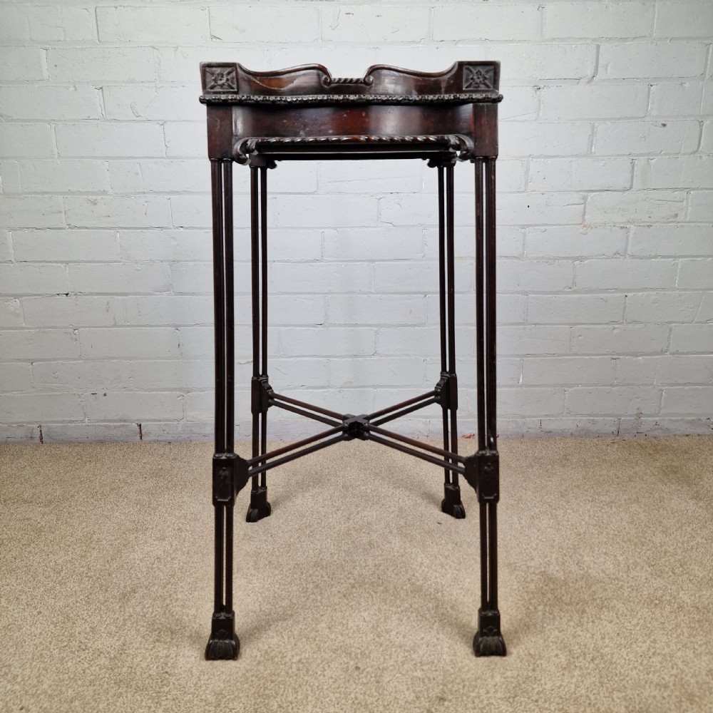 A tall, slender late 18th-century Chinese Chippendale style dark mahogany kettle stand featuring a carved gallery top, clustered column legs, and an X-frame stretcher. View VI