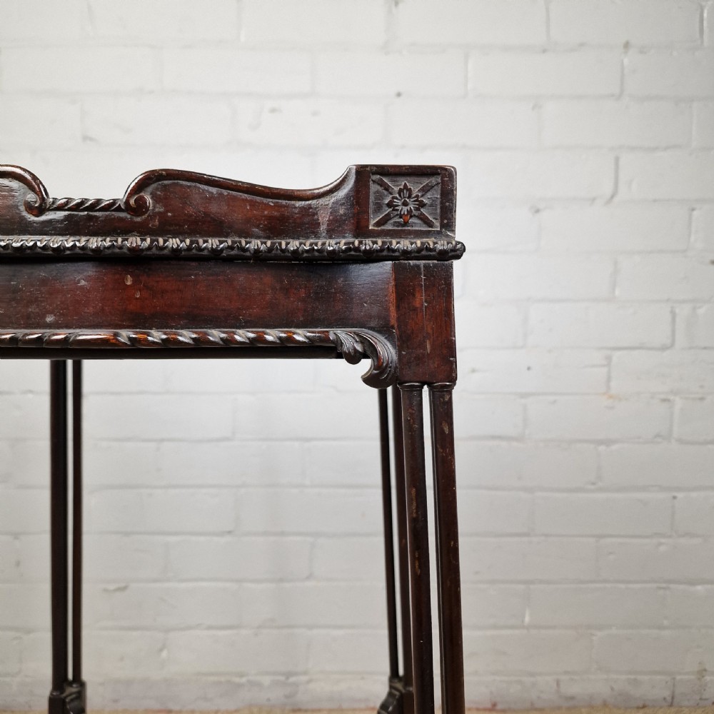 A tall, slender late 18th-century Chinese Chippendale style dark mahogany kettle stand featuring a carved gallery top, clustered column legs, and an X-frame stretcher. View VII