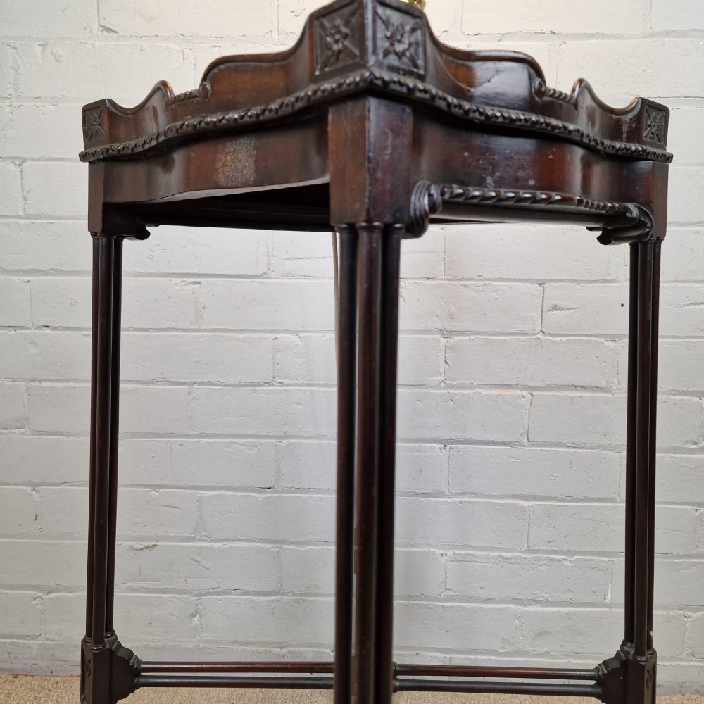 A tall, slender late 18th-century Chinese Chippendale style dark mahogany kettle stand featuring a carved gallery top, clustered column legs, and an X-frame stretcher. View IX