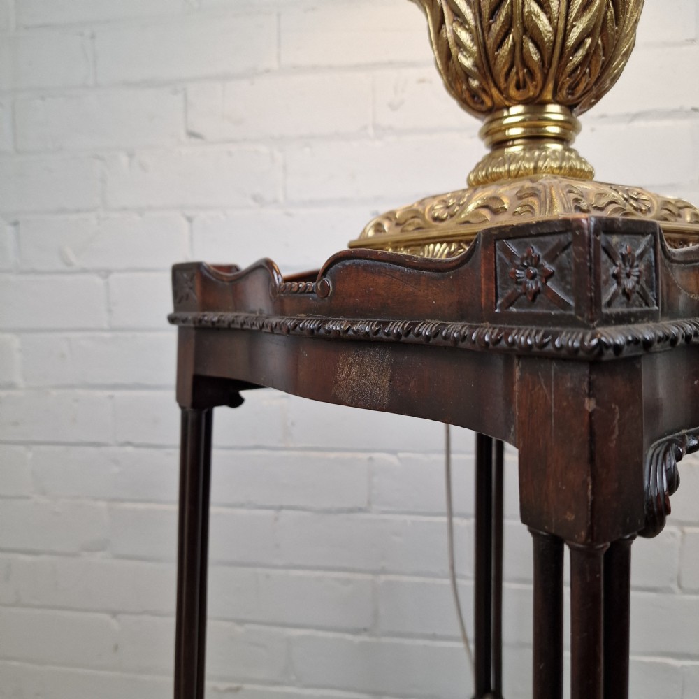 A tall, slender late 18th-century Chinese Chippendale style dark mahogany kettle stand featuring a carved gallery top, clustered column legs, and an X-frame stretcher. View X