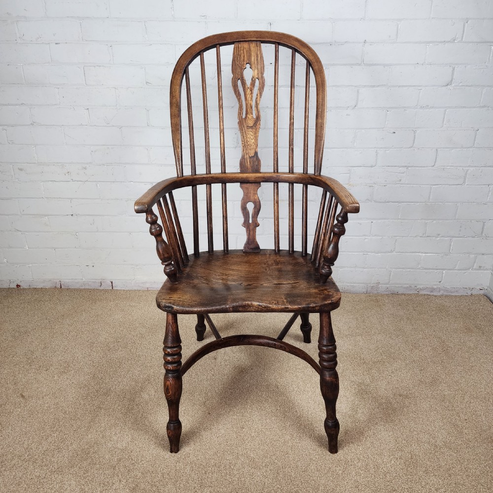 A 19th-century dark wood Windsor armchair featuring a high hoop back, pierced splat, turned legs, and a shaped elm seat. View II