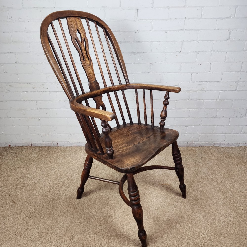 A 19th-century dark wood Windsor armchair featuring a high hoop back, pierced splat, turned legs, and a shaped elm seat. View III