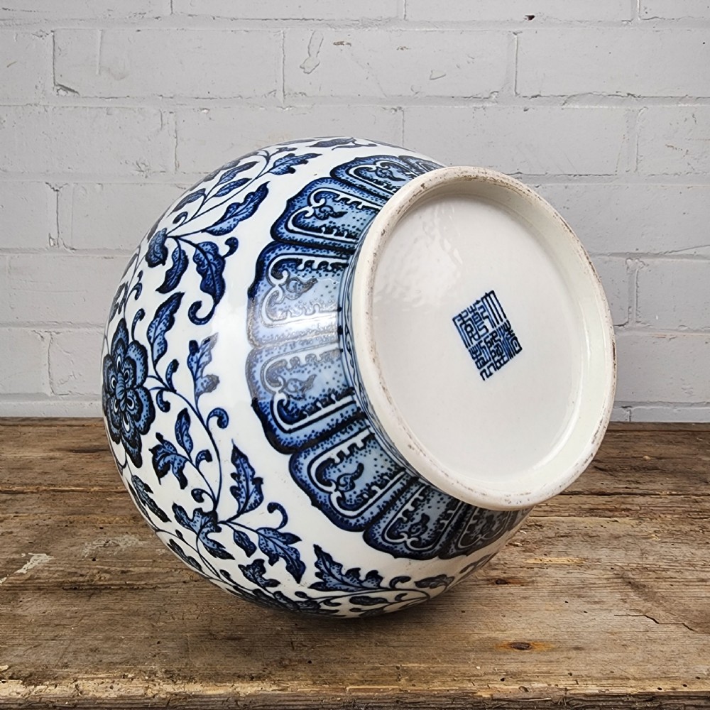 A Chinese blue and white porcelain bottle vase featuring hand-painted floral lotus scrolls and geometric leaf borders. View II