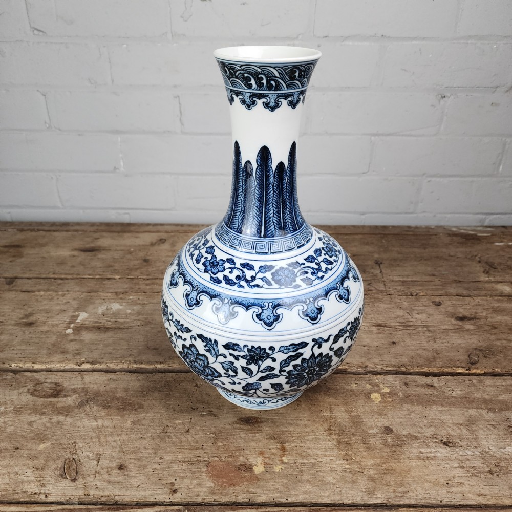 A Chinese blue and white porcelain bottle vase featuring hand-painted floral lotus scrolls and geometric leaf borders. View IV