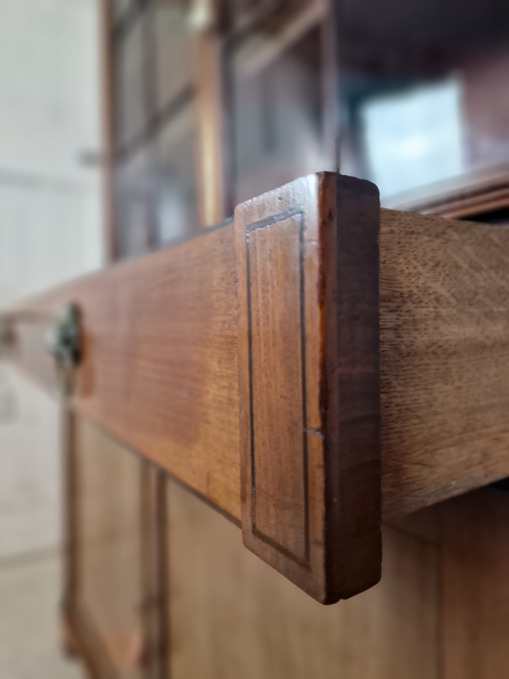 A George IV mahogany bookcase cupboard featuring glazed upper doors with Gothic arch glazing bars above a lower panelled cupboard. View V