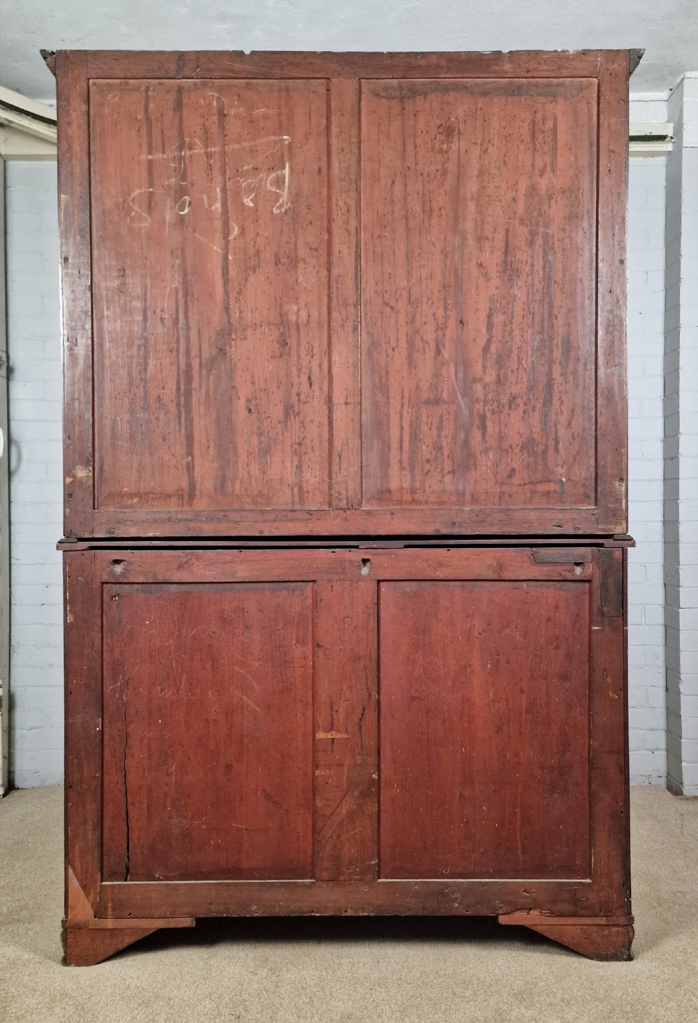 A George IV mahogany bookcase cupboard featuring glazed upper doors with Gothic arch glazing bars above a lower panelled cupboard. View XV