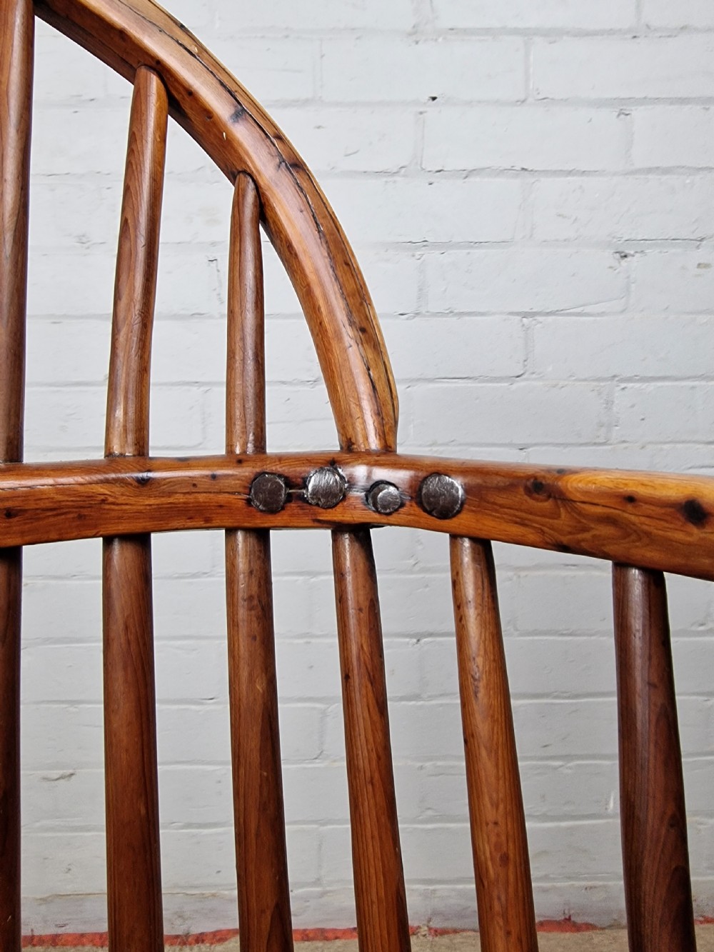An early nineteenth-century Windsor armchair crafted from yew and elm, featuring a hoop back, pierced central splat, turned legs, and a curved crinoline stretcher. View VIII
