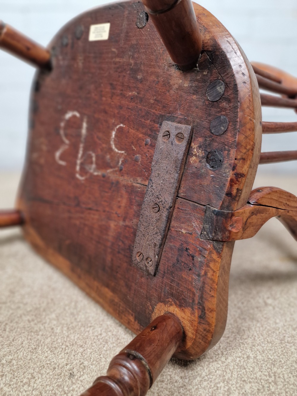 An early nineteenth-century Windsor armchair crafted from yew and elm, featuring a hoop back, pierced central splat, turned legs, and a curved crinoline stretcher. View IX