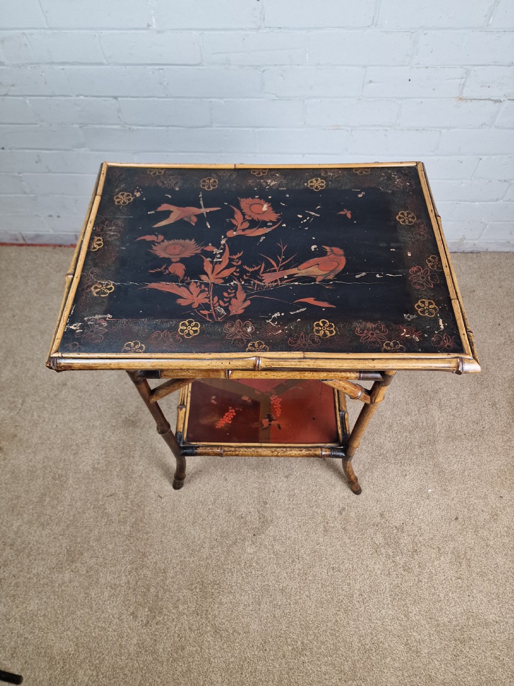 A 19th-century Aesthetic Movement side table crafted from bamboo with a dark lacquered top panel featuring floral hand-painted details and an undertier. View V