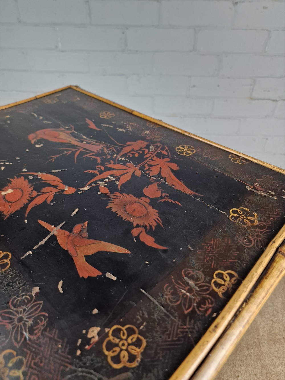 A 19th-century Aesthetic Movement side table crafted from bamboo with a dark lacquered top panel featuring floral hand-painted details and an undertier. View VII